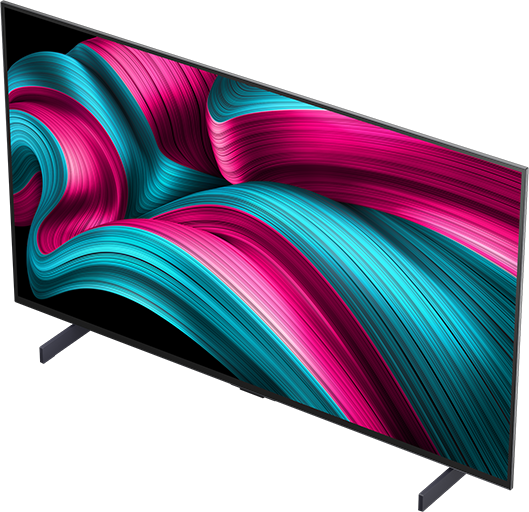 A TV képernyője egy színes, absztrakt mintát mutat rózsaszín és türkiz színekben.