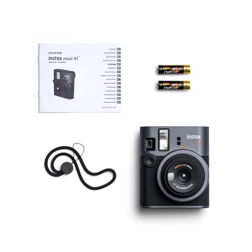 Cámara Instax Mini 41 negra, accesorios y manual sobre fondo blanco.
