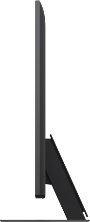Fekete számítógép-monitor oldalsó profilja, karcsú, minimalista dizájnnal, fekete háttér előtt.