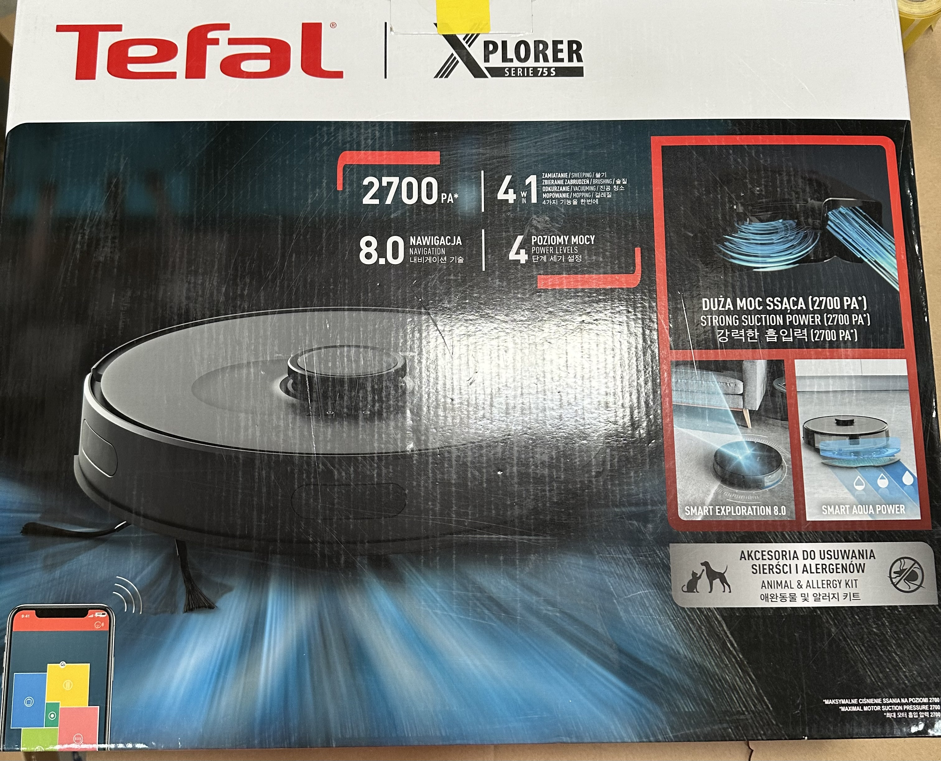 Pudełko zawierające odkurzacz automatyczny ze szczegółami produktu.