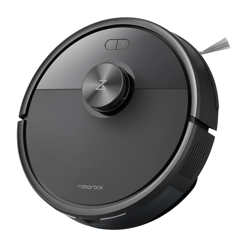 Czarny odkurzacz robot na białej powierzchni, widok z góry.