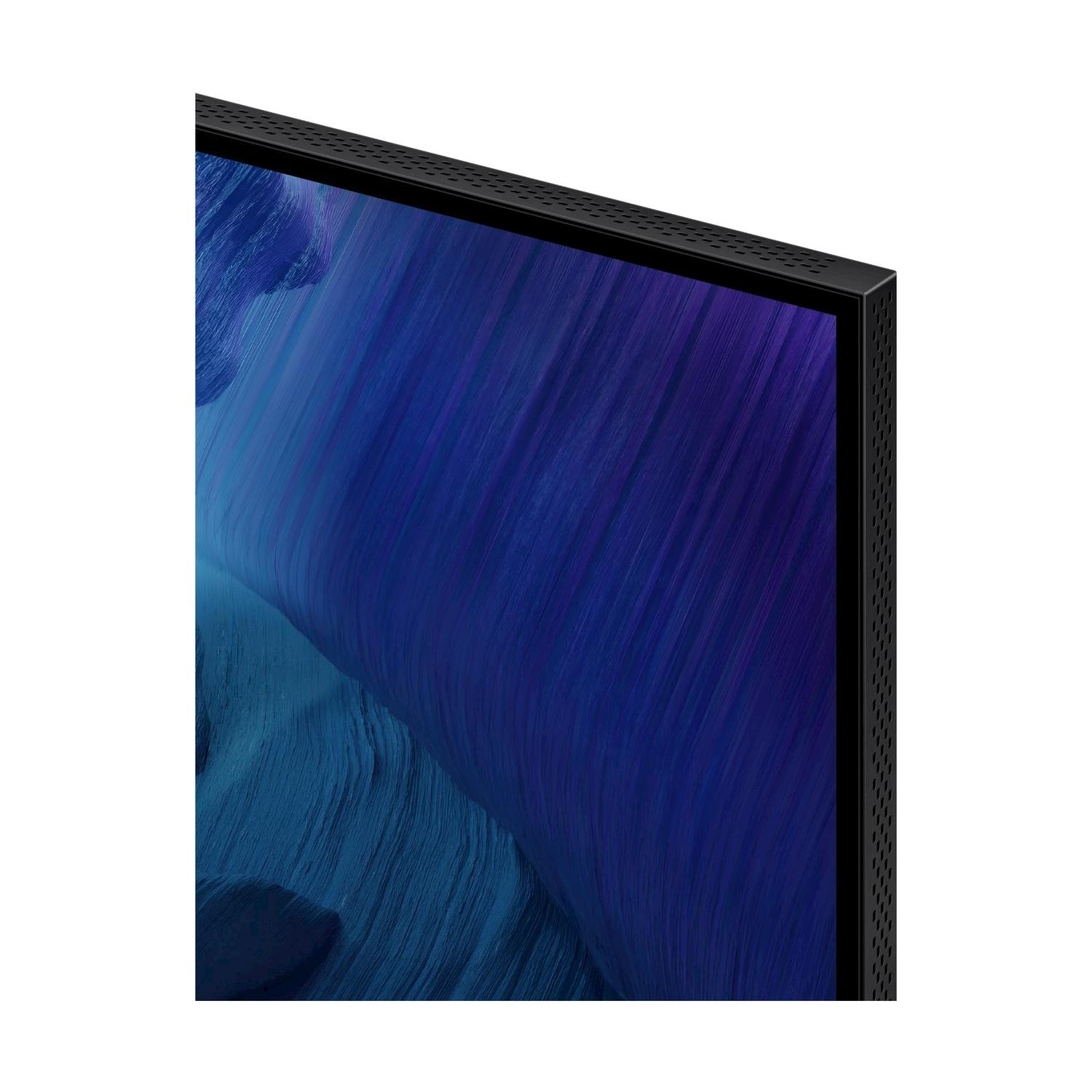 Primo piano di un angolo TV con cornice scura e immagine blu e viola.