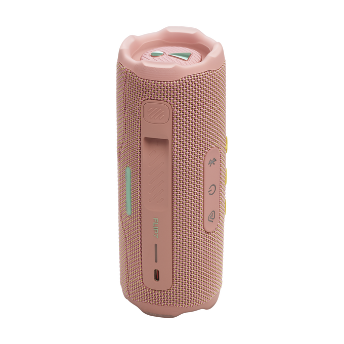 Un altavoz portátil JBL Flip 7 rosa. Tiene botones, una textura similar a la tela y un diseño tipo asa. El fondo es negro.