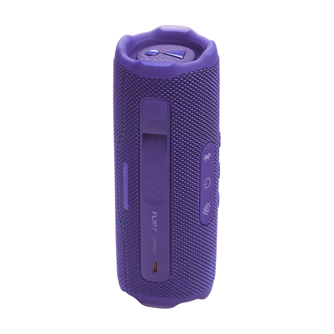 Altavoz morado JBL Flip 7, forma cilíndrica, con botones y puerto de carga visibles.