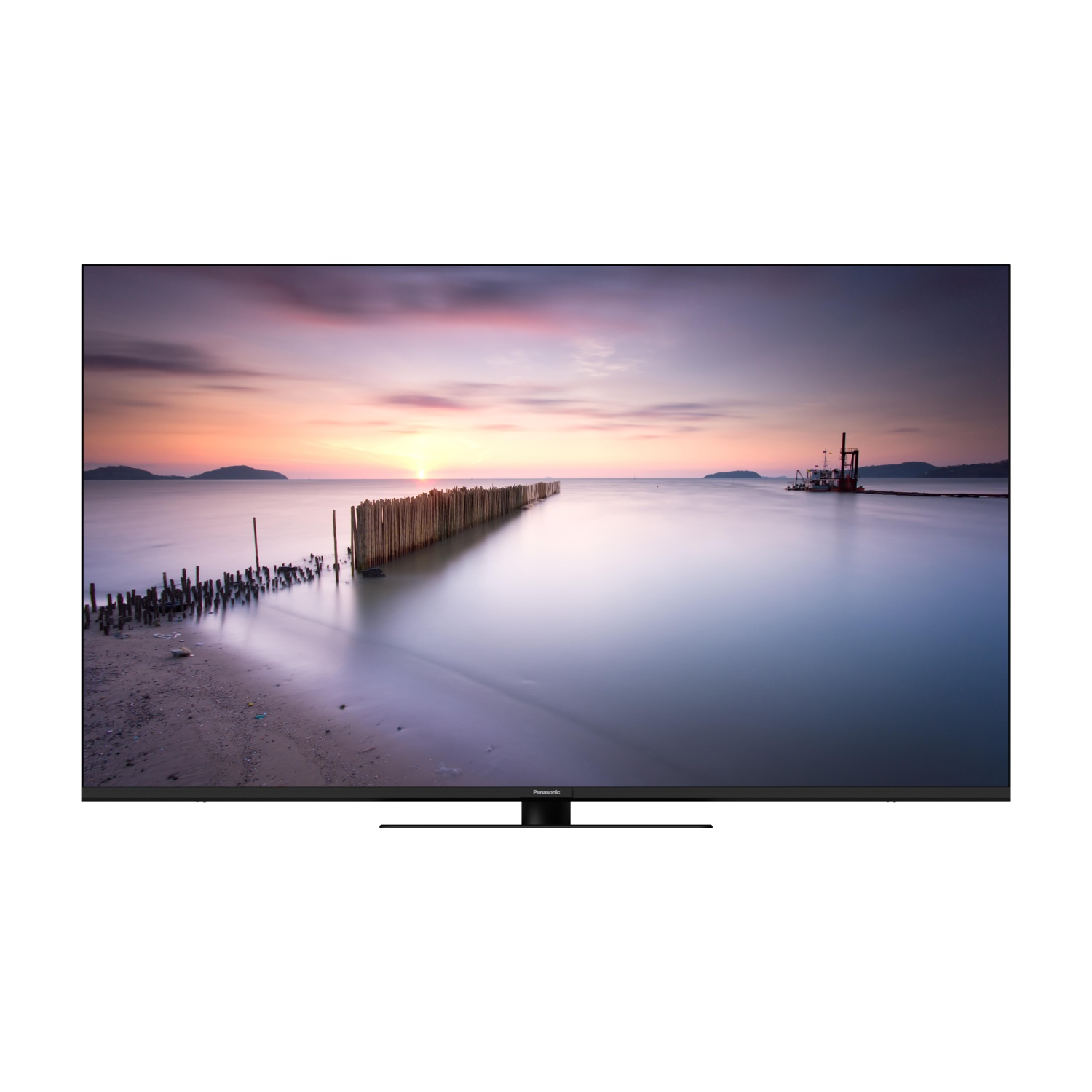 Un televisore Panasonic mostra un tramonto su una spiaggia con una barriera di legno.