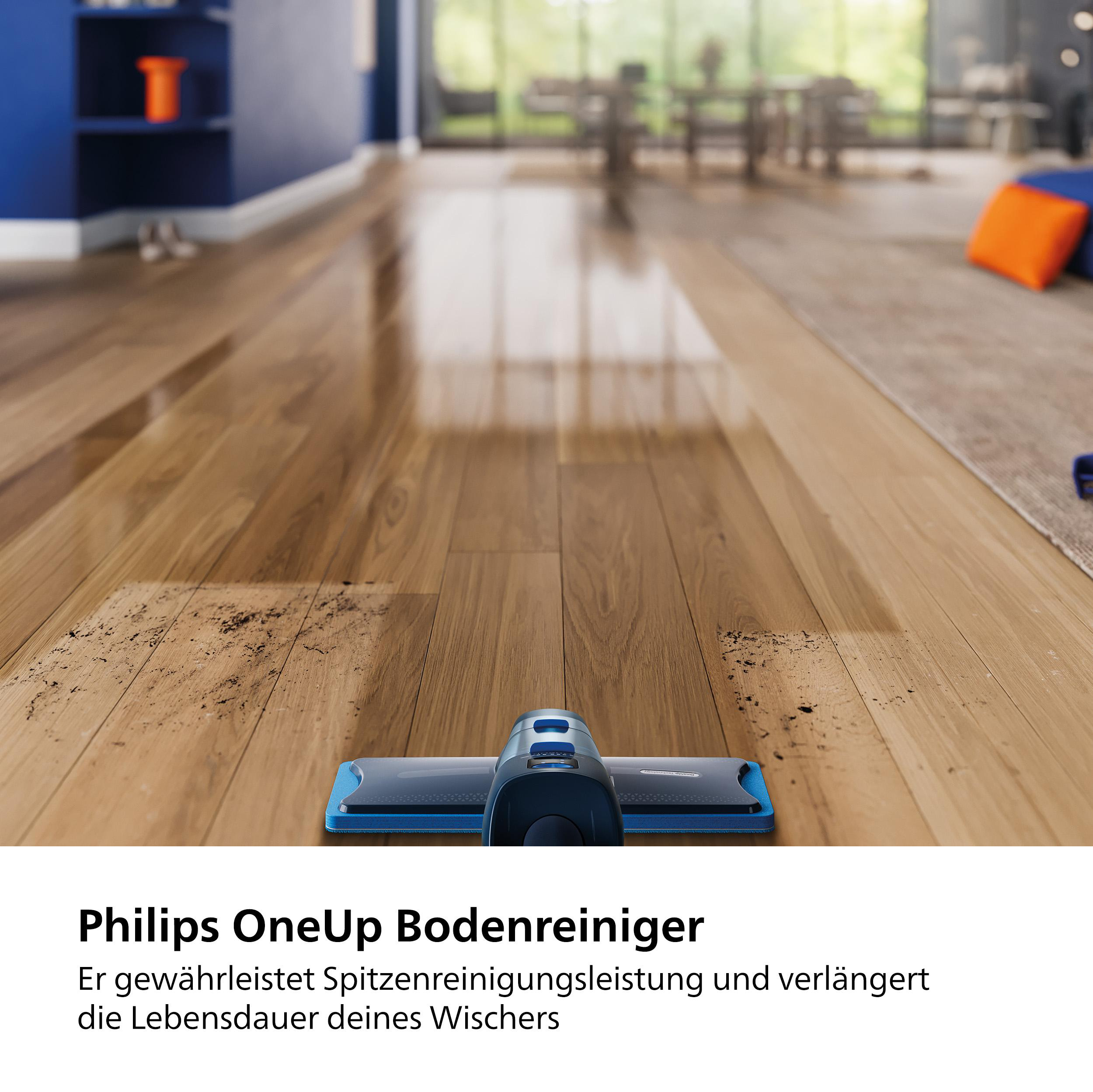 Ein Bodenreinigungsgerät auf einem Holzboden mit etwas Schmutz.