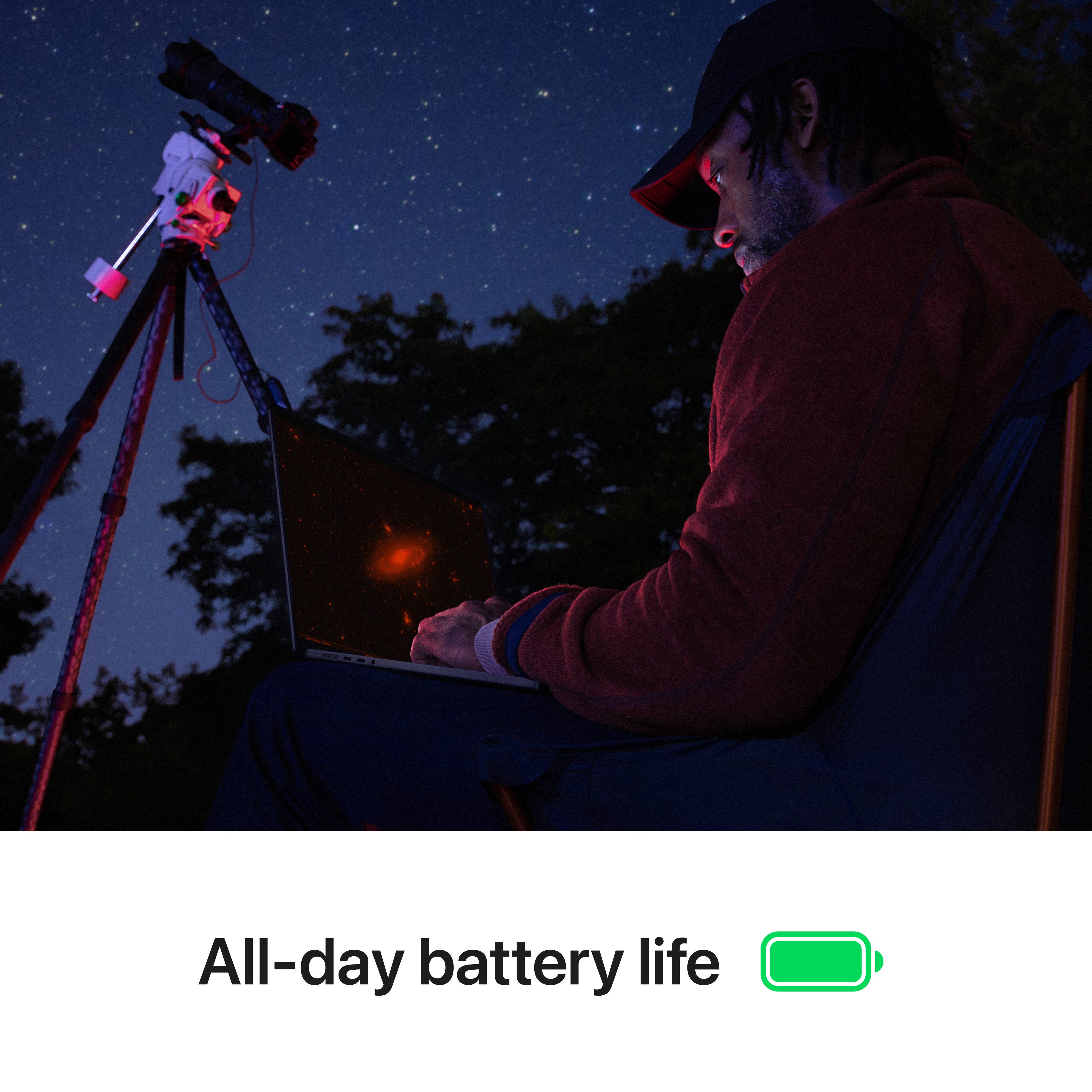 Mann benutzt Laptop bei Nacht, Teleskop, Sternenhimmel. Ganztägige Akkulaufzeit wird gezeigt.