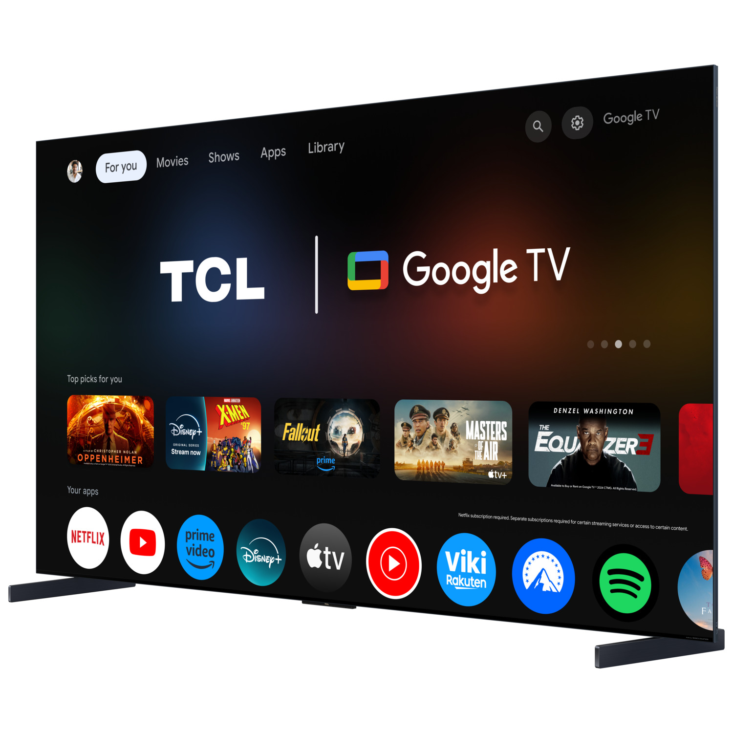 TCL Google TV on display, with apps icons and a black stand. The background is blurred.