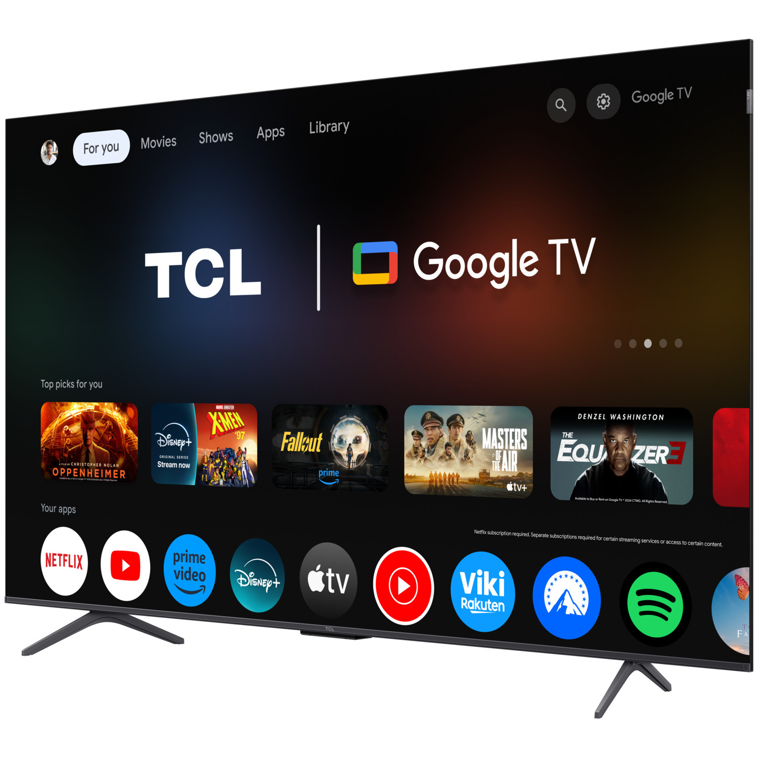 TCL Google TV screen with app icons. Movies, shows, and apps are displayed. Black TV stand.