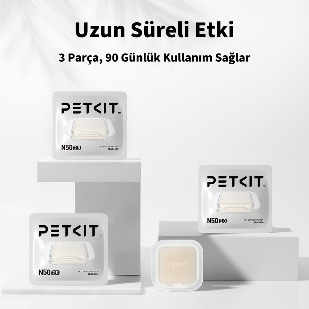 Dört PETKIT evcil hayvan kokusu giderici paketi. Önde üç tane, arkada bir tane kaide üzerinde.