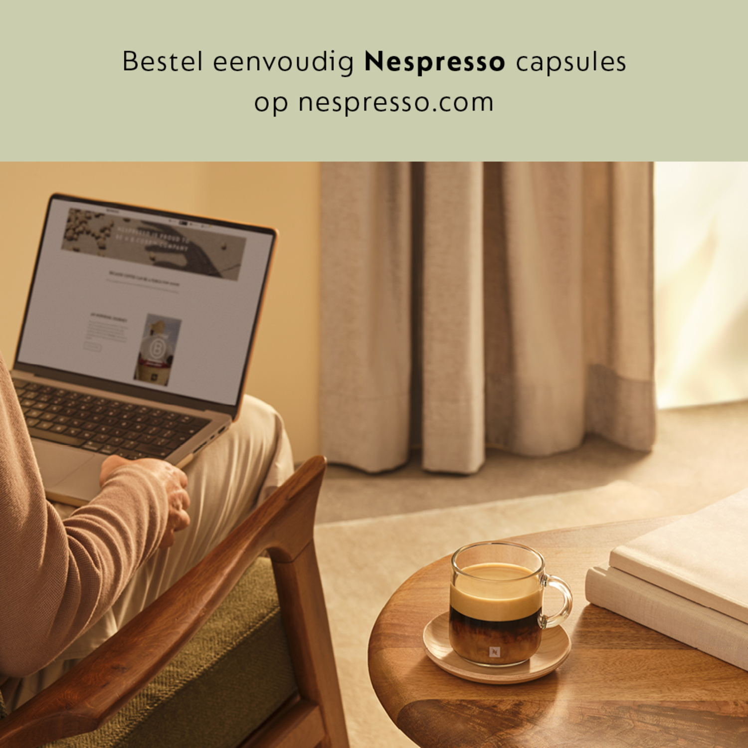 A woman using a laptop, with a coffee cup nearby.