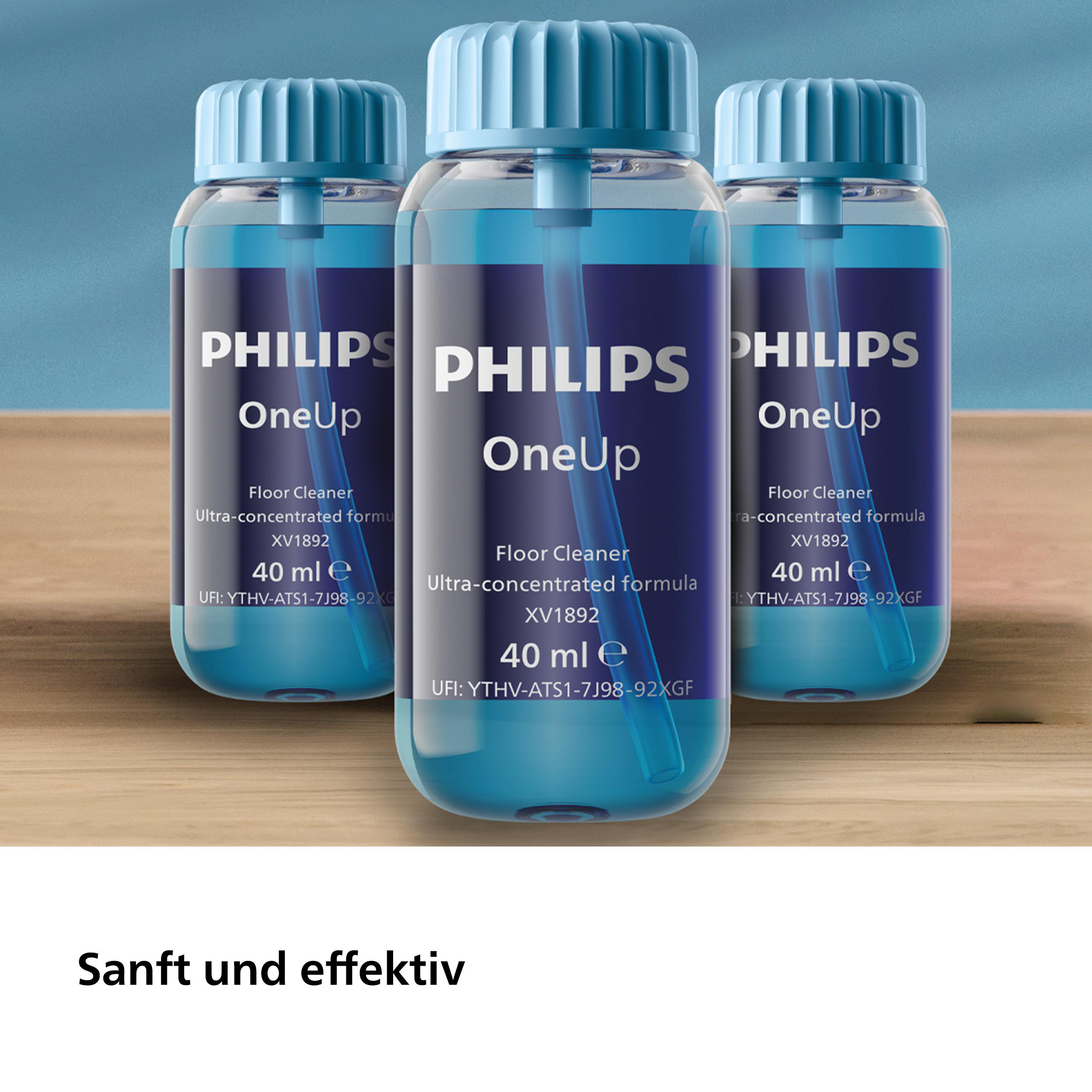 Drei Flaschen Philips OneUp Bodenreiniger. Die Flaschen sind blau mit weißen Etiketten. Unscharfer Hintergrund.