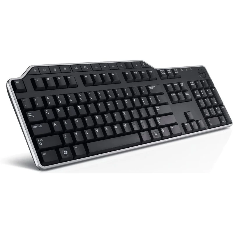 Teclado Dell negro con ribete plateado. Las teclas son negras con letras blancas. El teclado está sobre una superficie blanca.