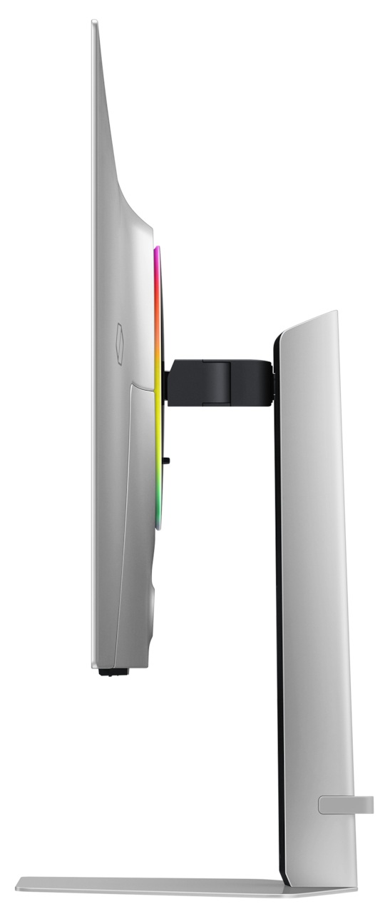 Srebrny monitor komputera na stojaku. Ma kolorowy pasek świetlny z boku.