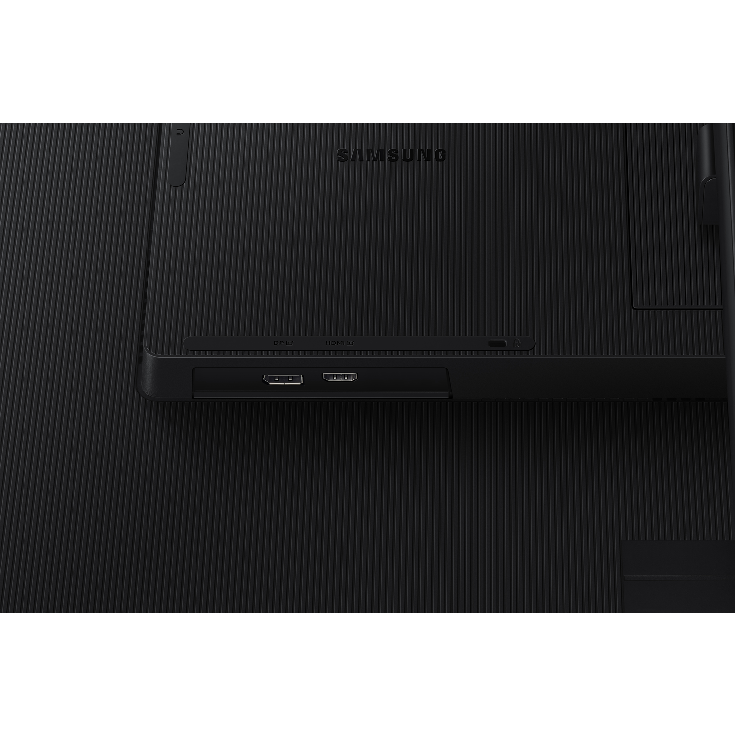 Close-up on back of a black monitor. Showing ports including HDMI and other input options.