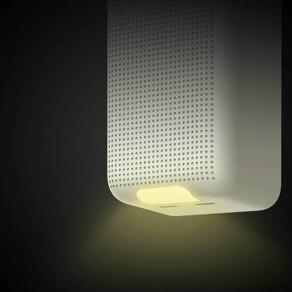 Un haut-parleur blanc avec de la lumière émise par le bas.