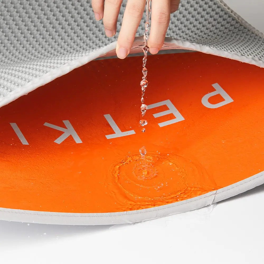 De l'eau versée sur un tapis orange pour animaux de compagnie.