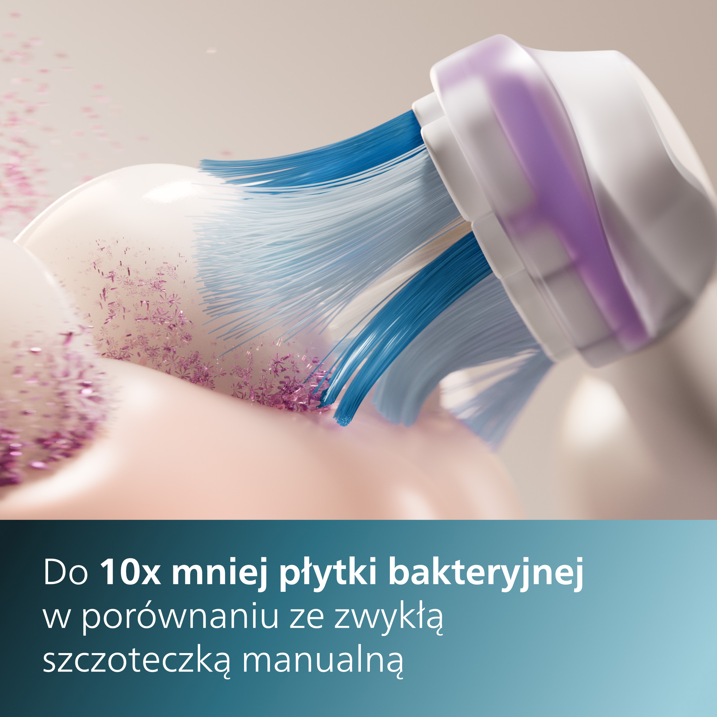 Zbliżenie główki szczoteczki elektrycznej z niebieskim i białym włosiem. Widoczne różowe cząsteczki.