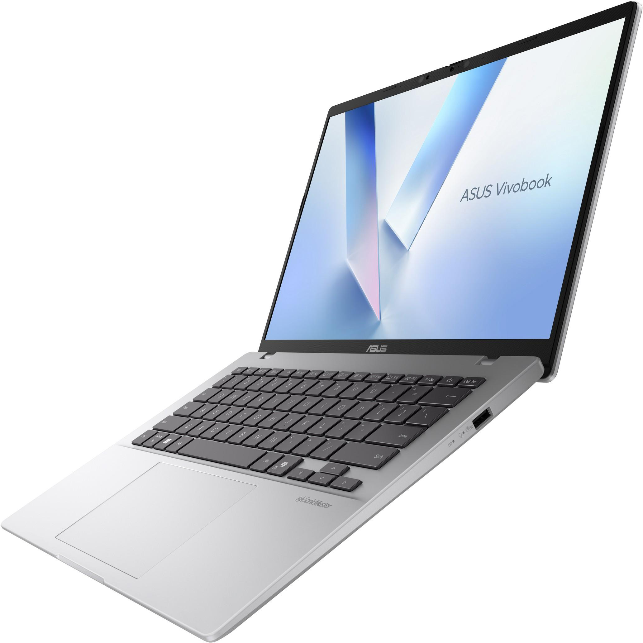 Ezüst laptop, nyitva fehér felületen, 'ASUS Vivobook' szöveggel a képernyőn.