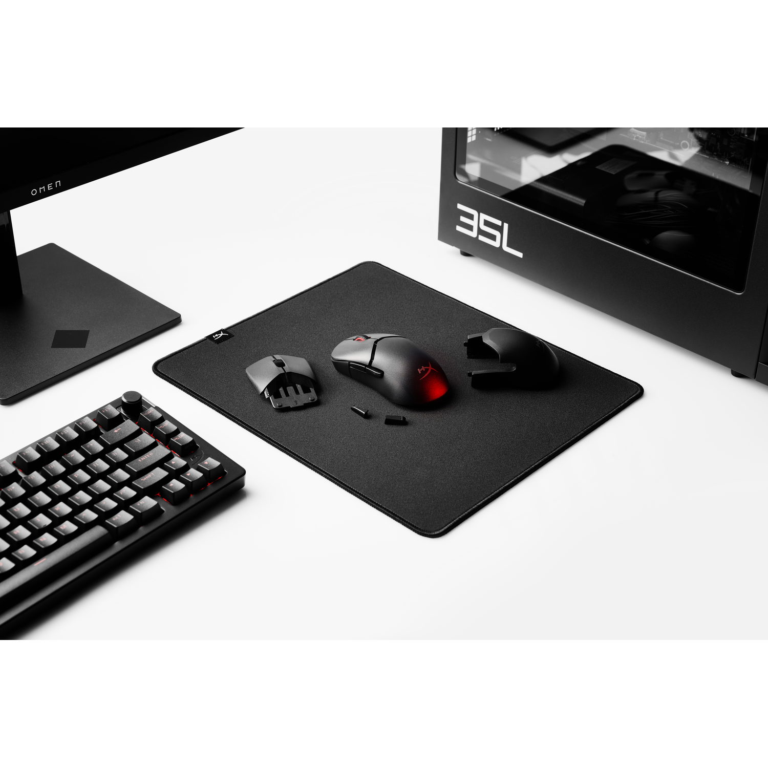 Black keyboard, mouse, and mousepad setup.  Three mice are visible.  Black on white background.