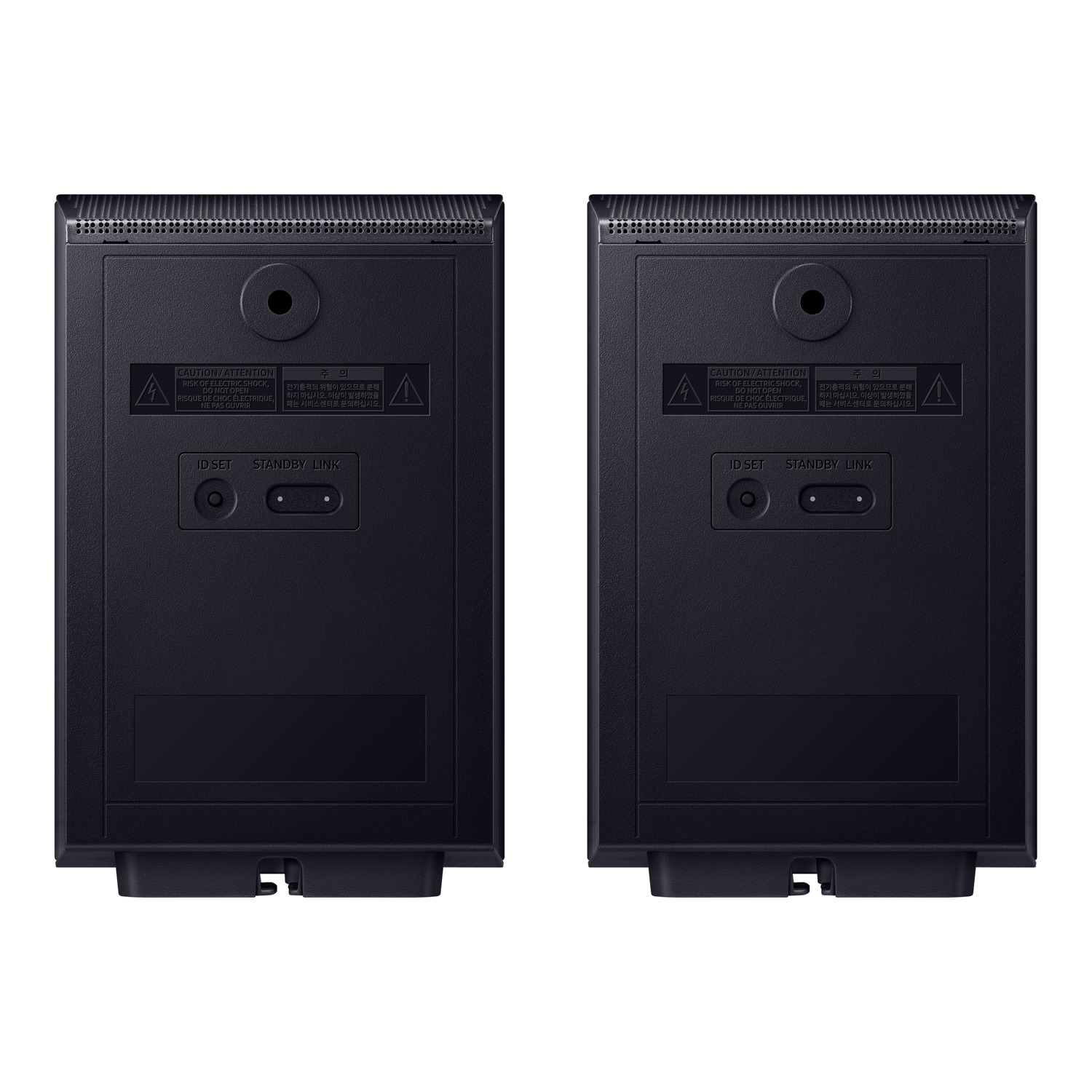 Deux enceintes noires, avec des étiquettes et des avertissements au dos.