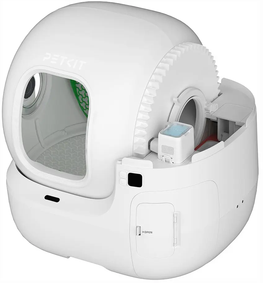 Litière automatique blanche pour chats. Ouverte, montrant l'intérieur et un mécanisme rotatif.
