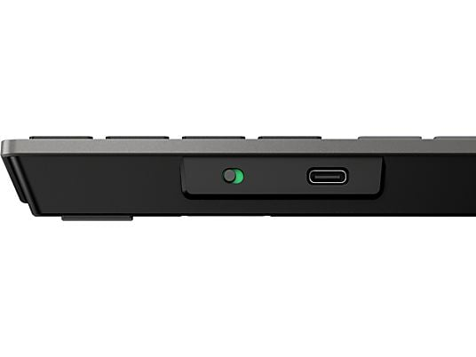 Een close-up van de zijkant van een zwart toetsenbord. Het heeft een aan/uit-knop, een USB-C-poort en een donkergrijs frame.
