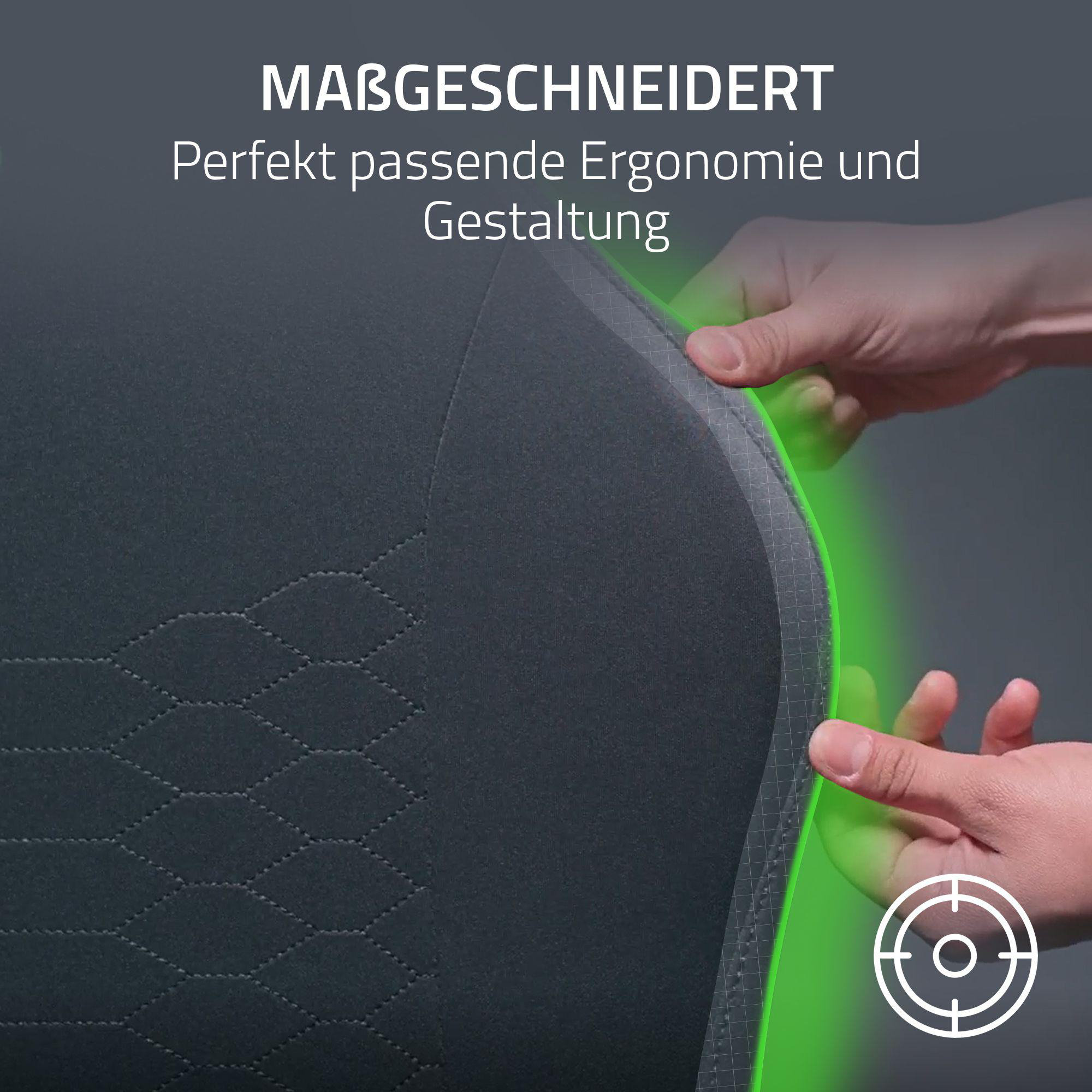 Hände berühren einen grauen Stuhl mit grünen Akzenten.