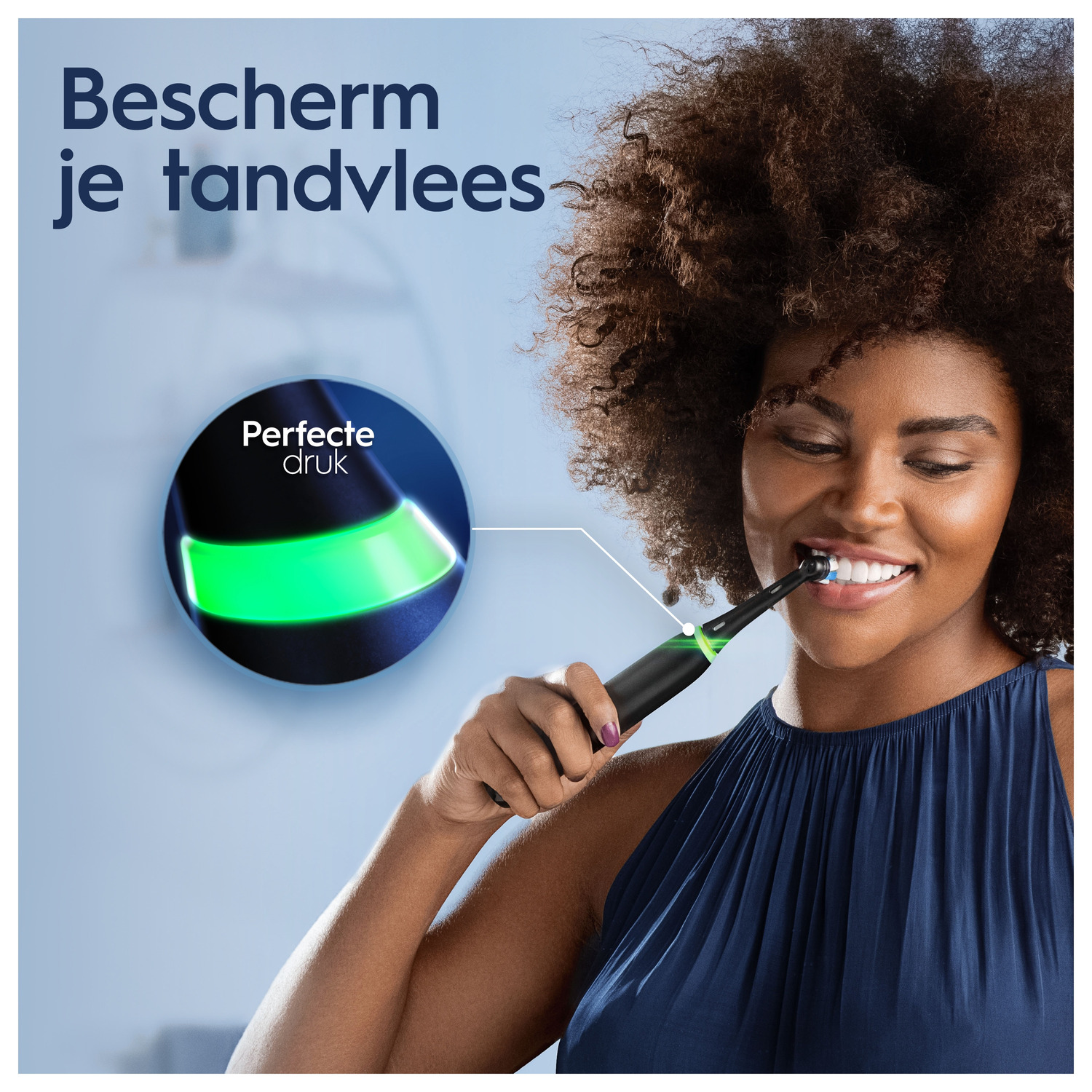 A woman brushing her teeth with a black and green electric toothbrush, with a visual indicator.