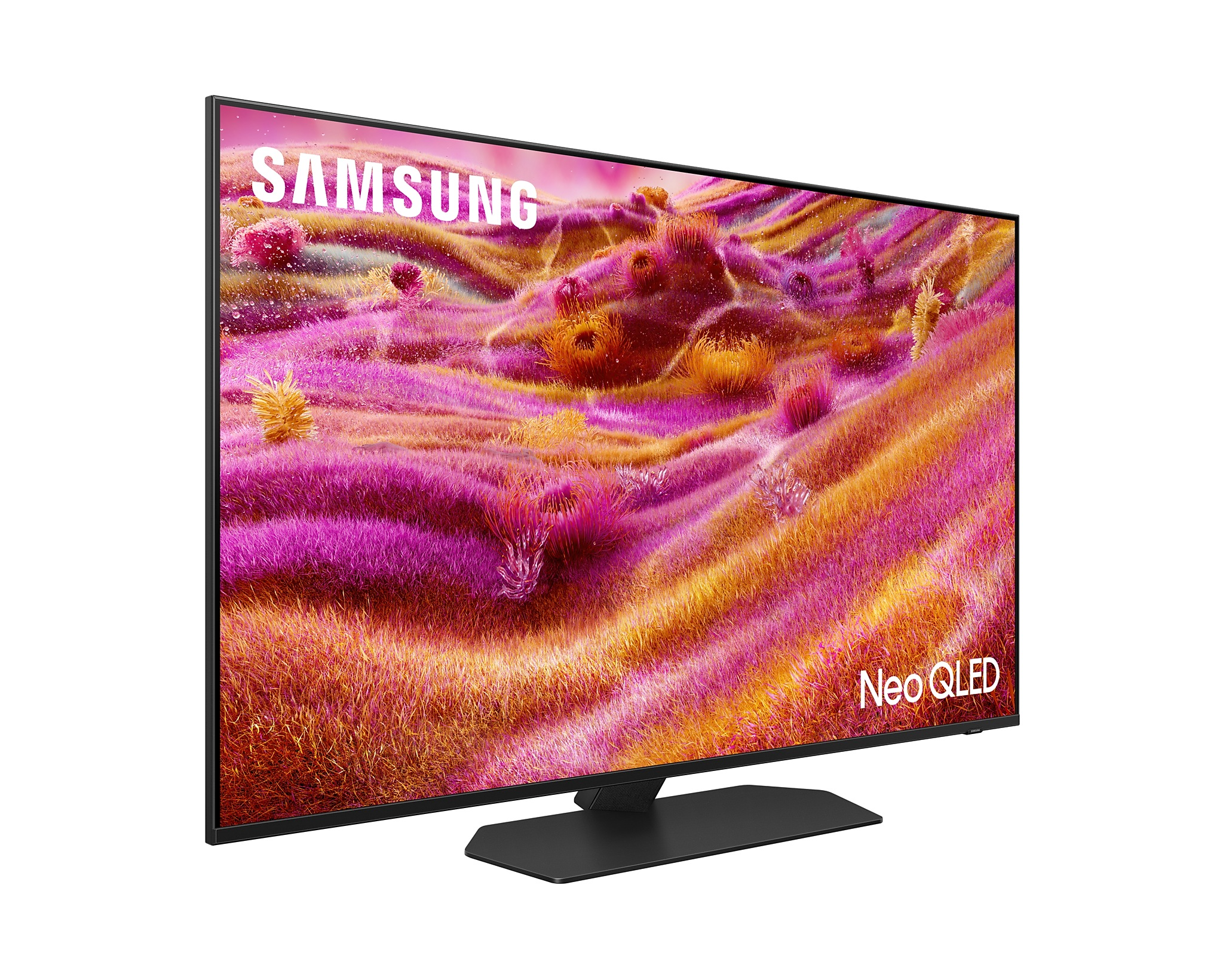 Egy Samsung TV fekete állvánnyal. A képernyő rózsaszín és sárga absztrakt tájat mutat.