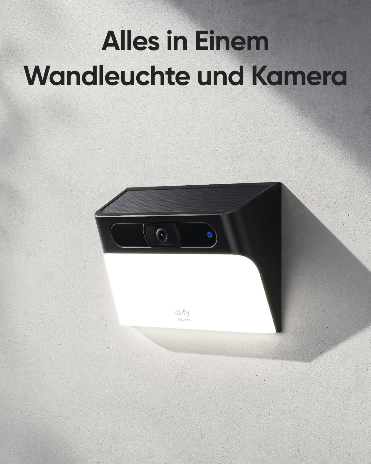Eine Wand-Sicherheitskamera und Leuchte, schwarz und weiß, vor einer strukturierten Wand.