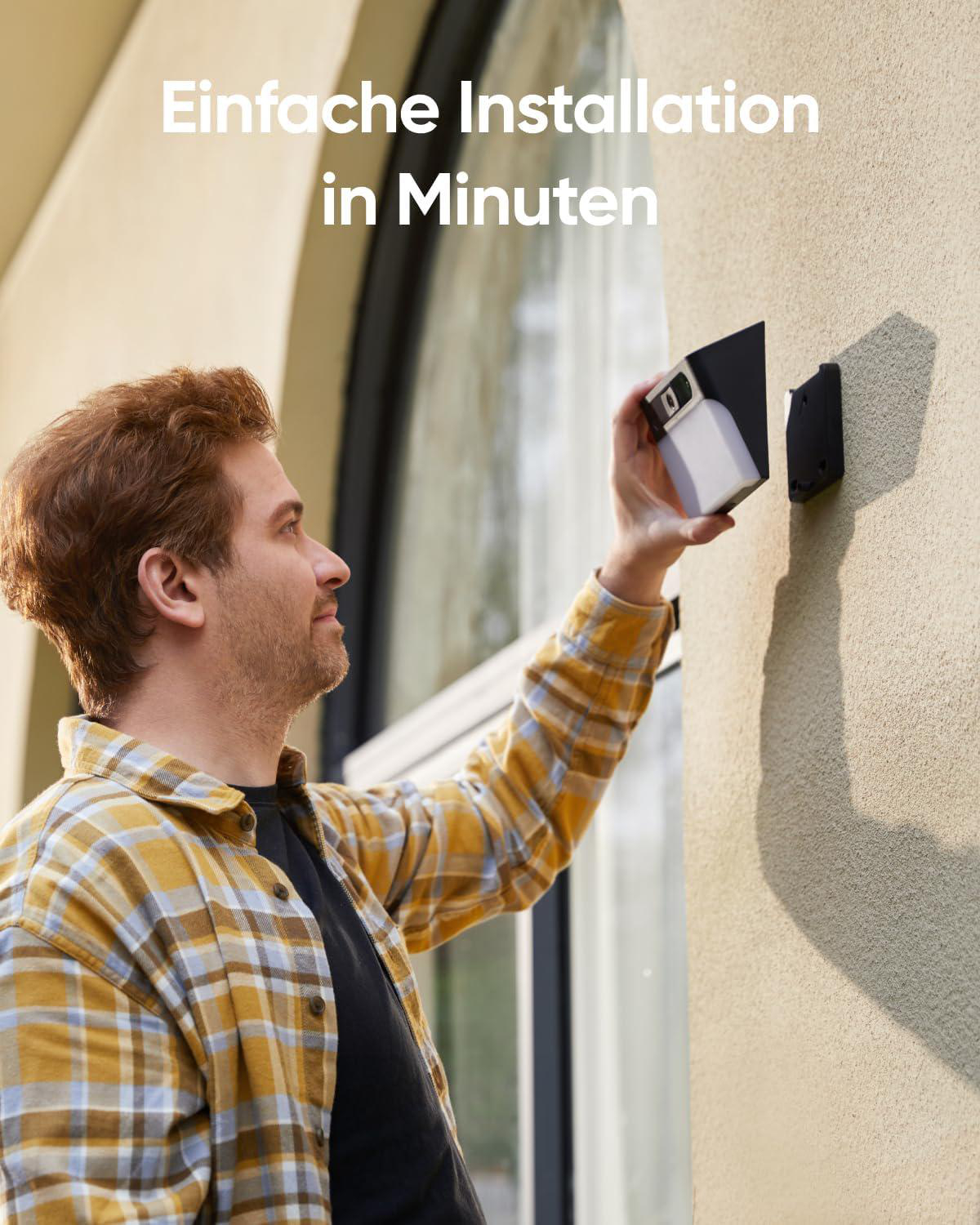 Mann installiert Gerät an Wand, Text: 'Einfache Installation in Minuten'.