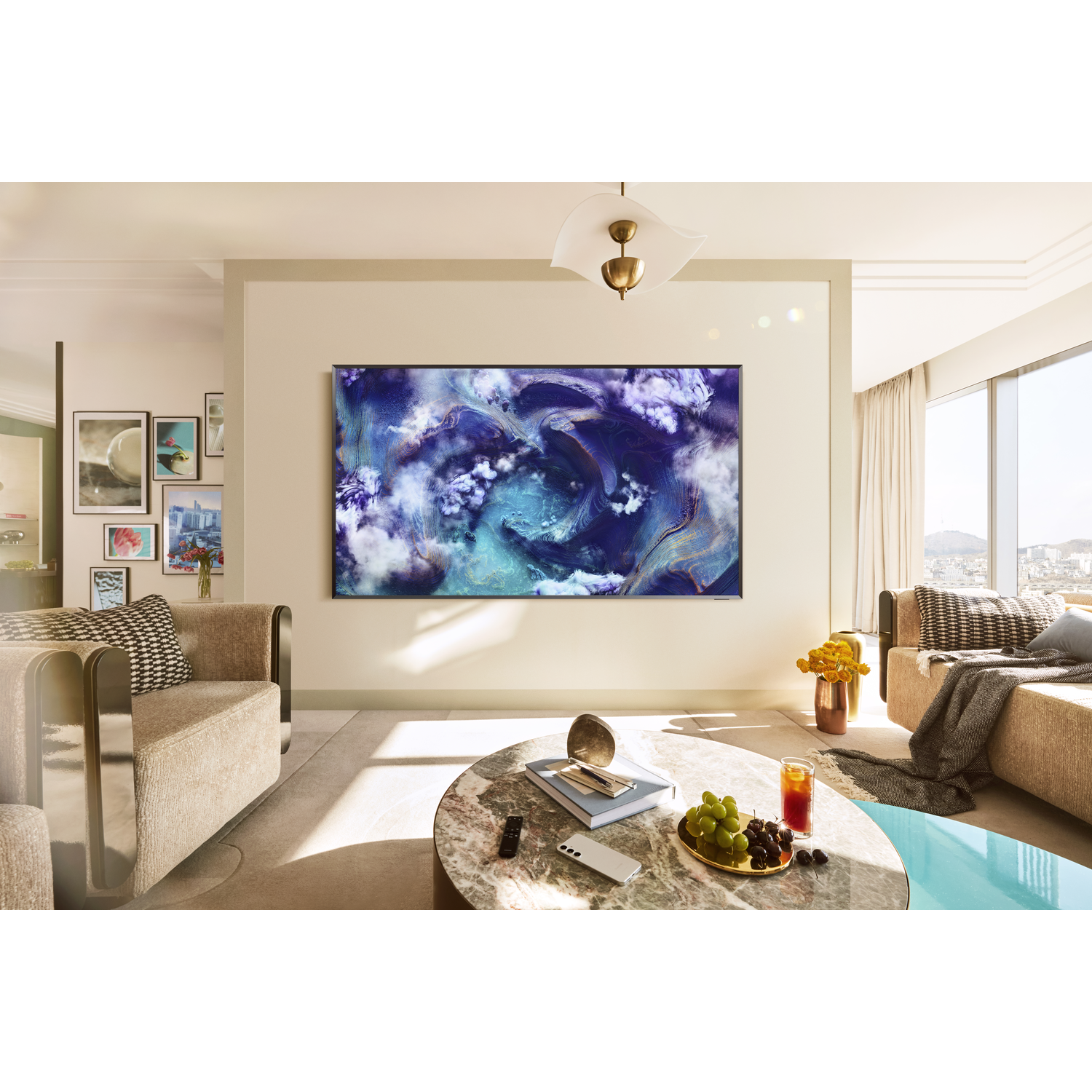 Living room with abstract art above a coffee table with fruit and drinks.