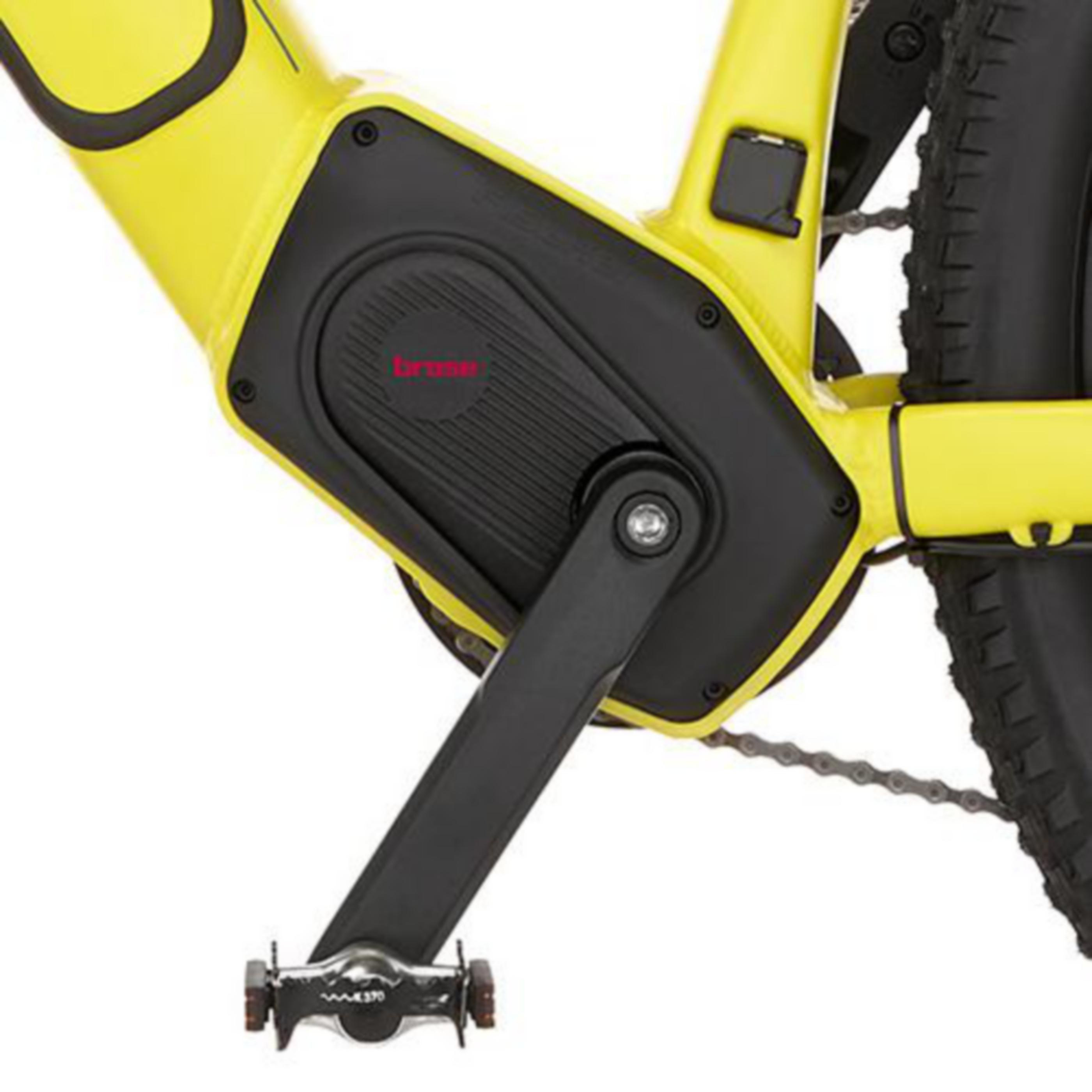 Nahaufnahme eines gelben Fahrradrahmens mit schwarzem Motor, Kurbelarm und Pedal.
