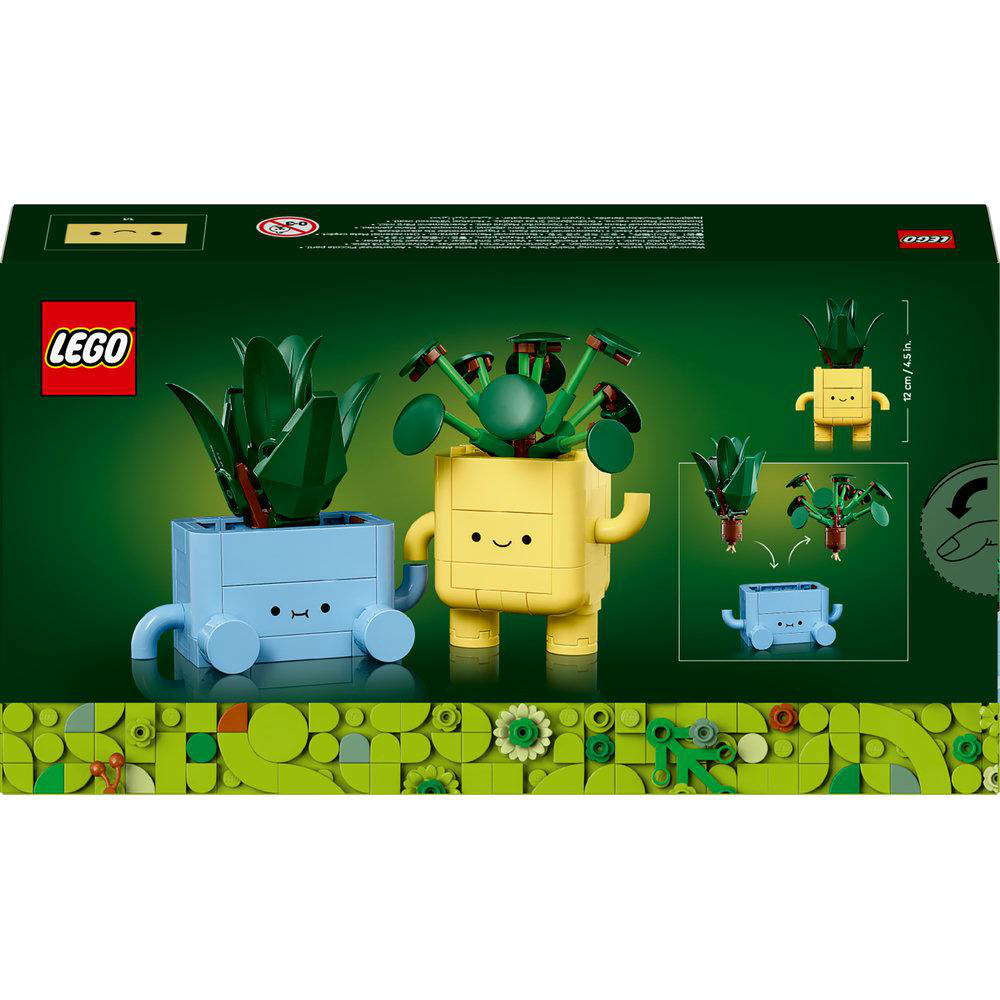 Lego-Set mit zwei Pflanzen in blauen und gelben Töpfen auf grünem Hintergrund.