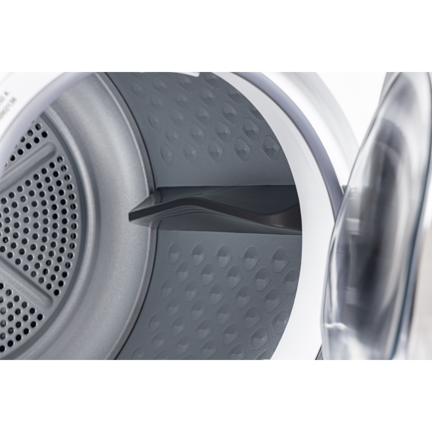 Inside a dryer drum. The interior is gray with a perforated metal section and a gray plastic paddle. The open door is visible.