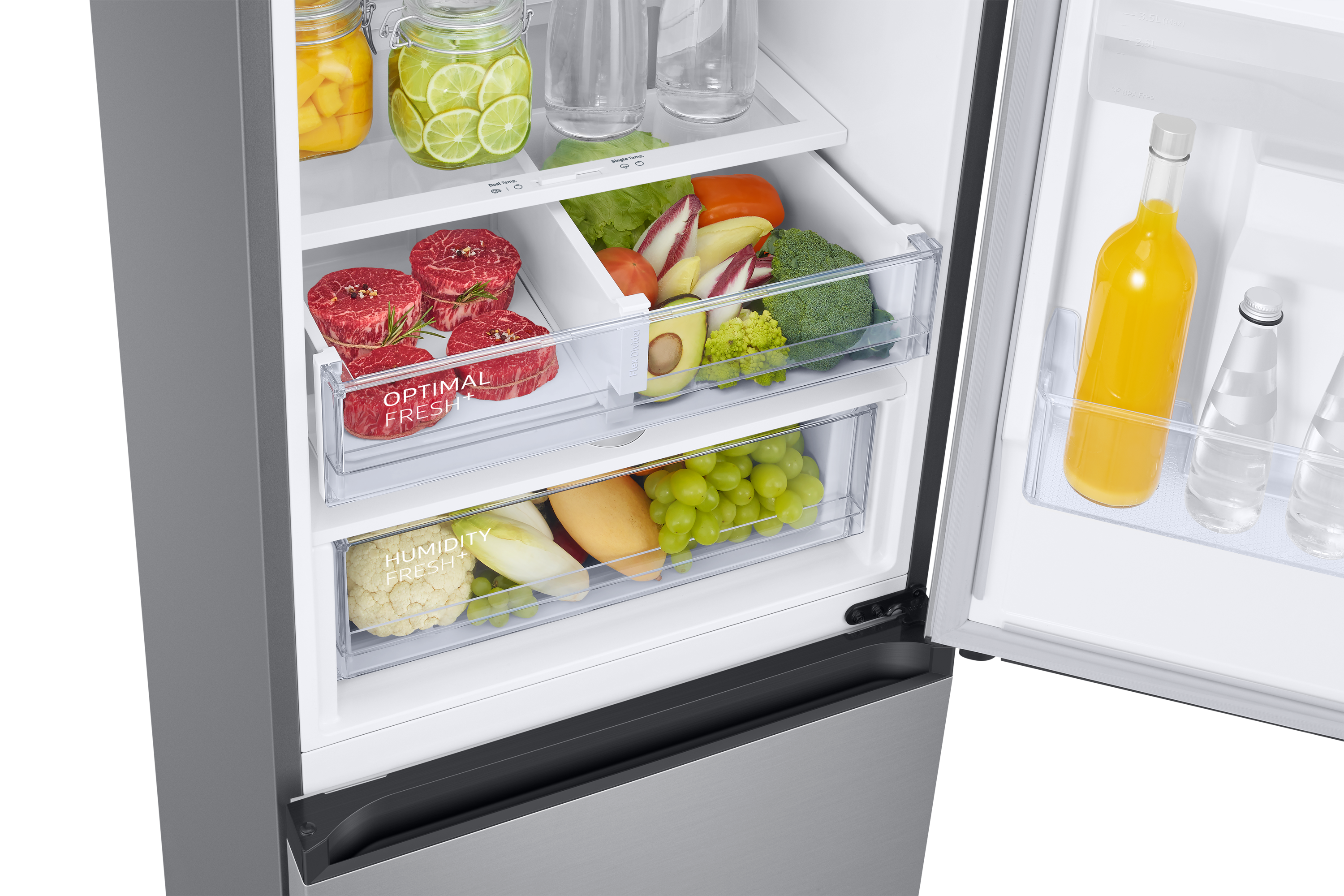 Close-up of a refrigerator with meat, vegetables, fruits, and juice bottles in drawers and shelves.