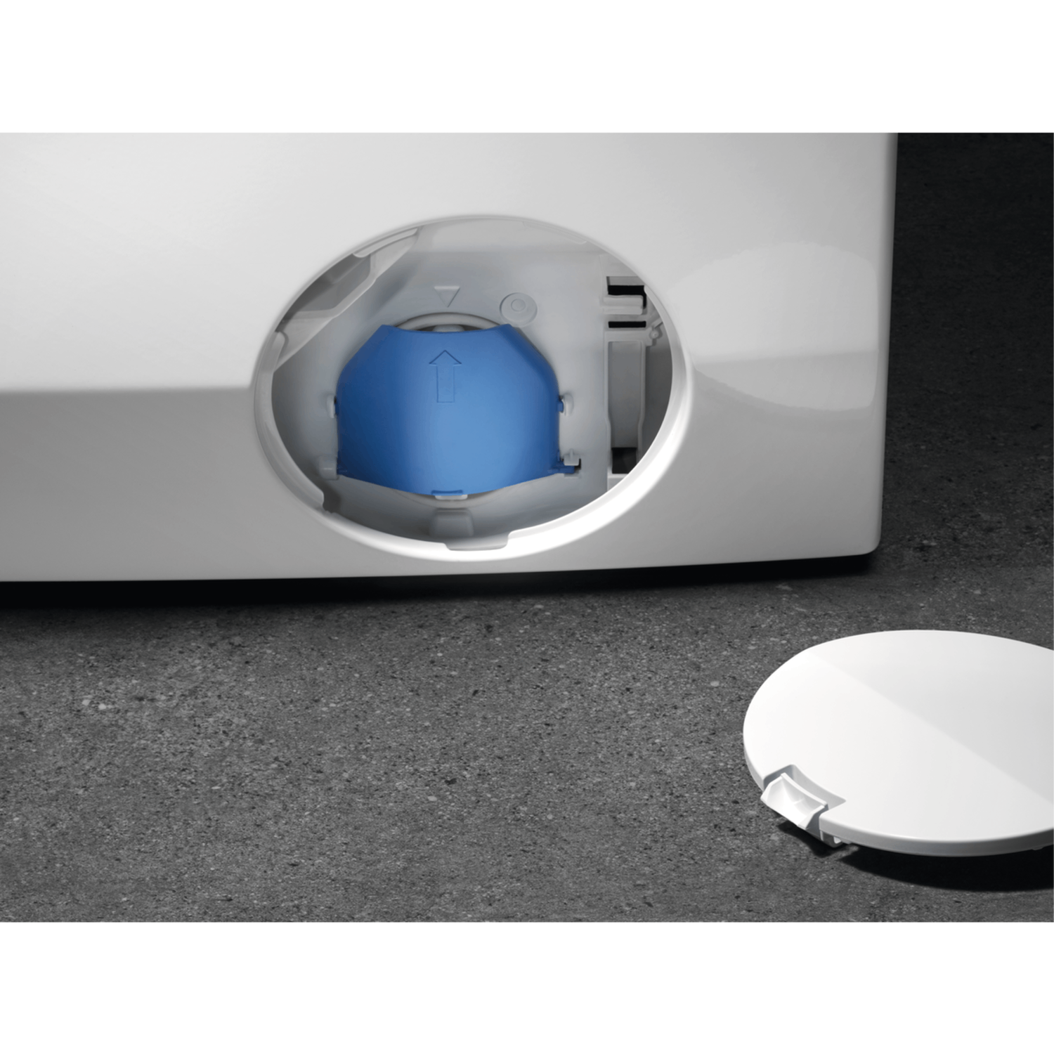 Close-up of a washing machine drain. It shows the blue closure and the white cover next to it.