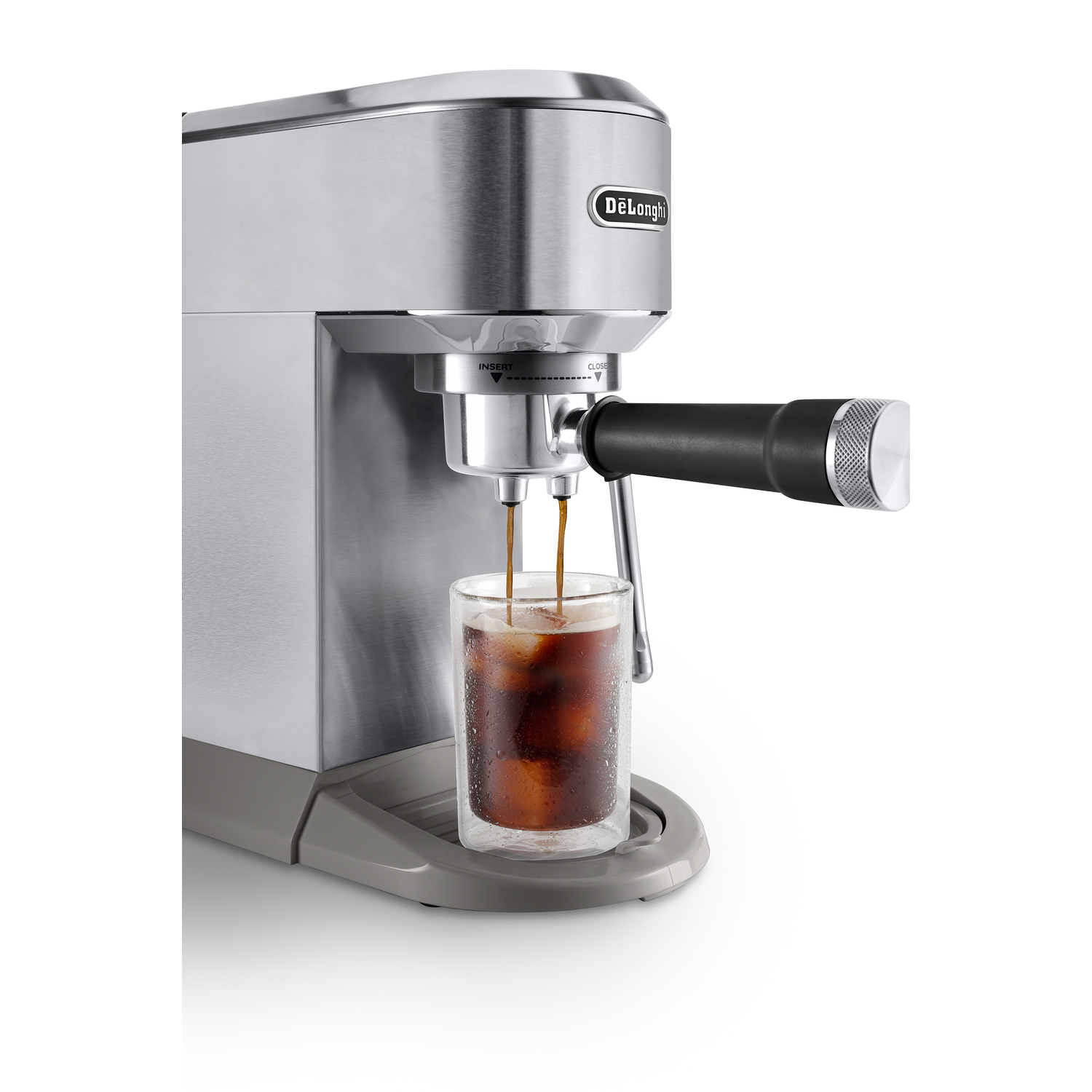 An espresso machine pouring espresso into a glass with ice. The background is white.