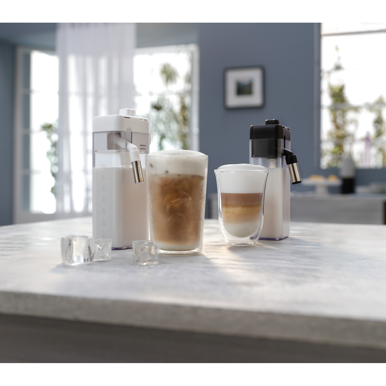 Three drinks on a counter: one with ice, one with foam, and a layered drink.