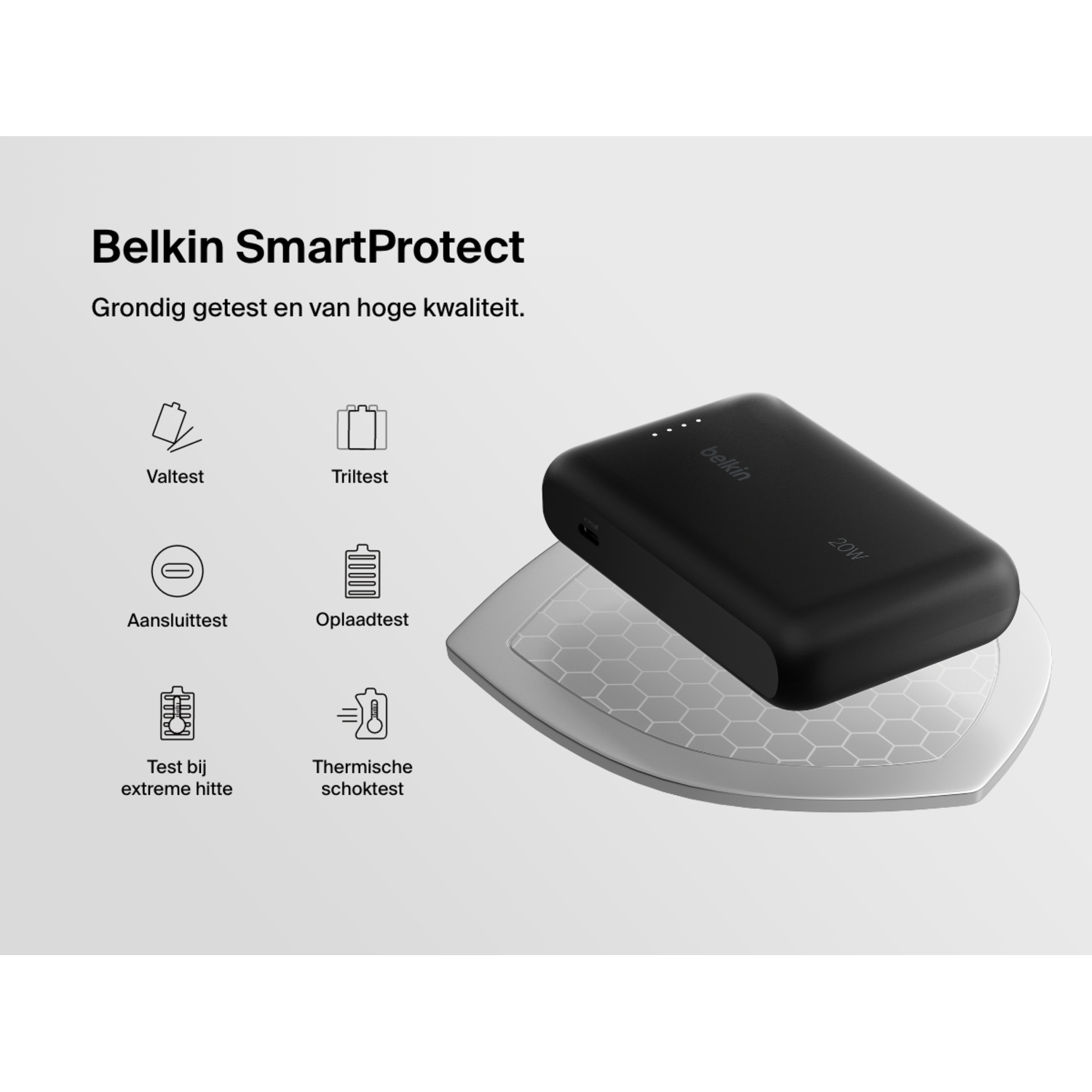 A black Belkin power bank on a white surface, with symbols for tests.