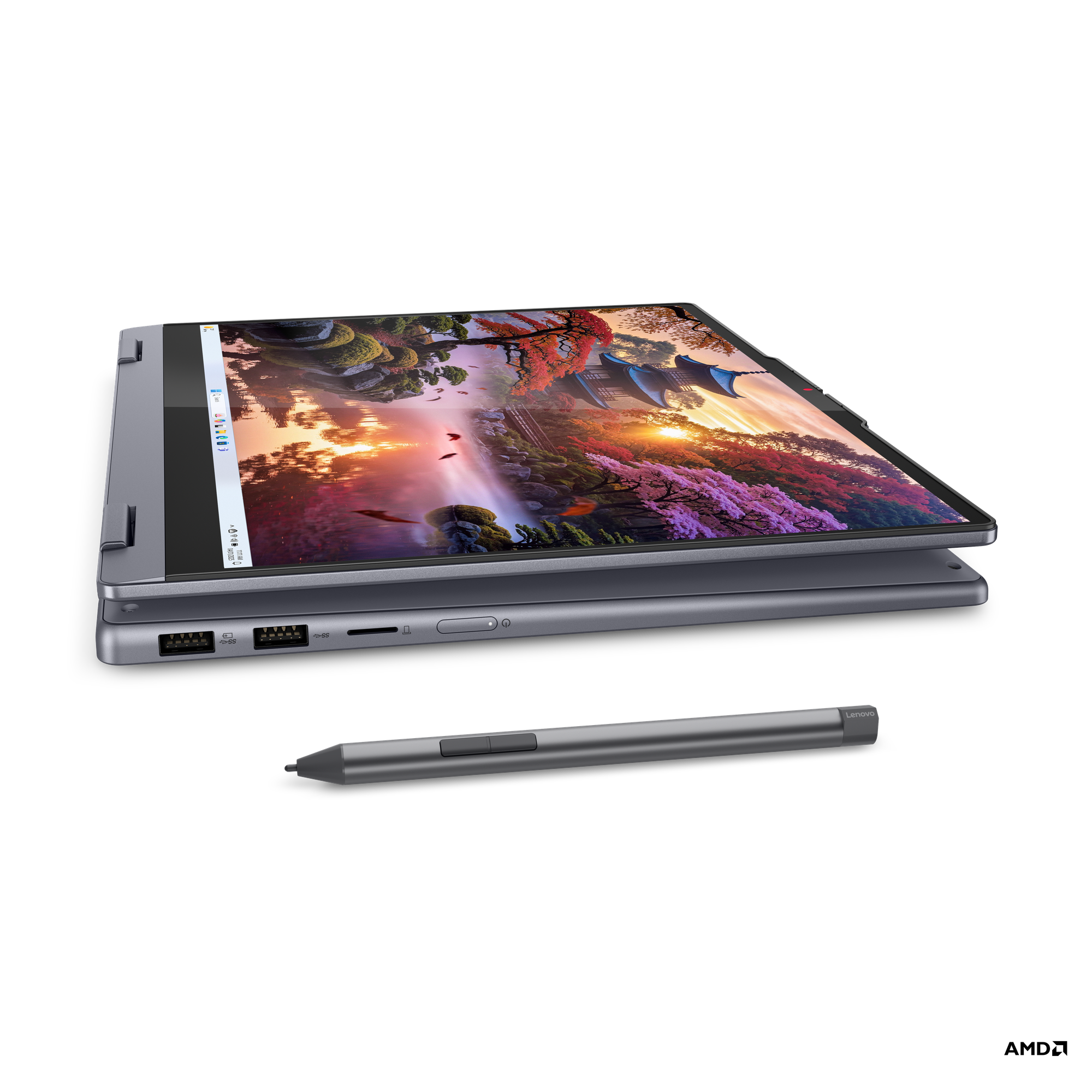 Manzara gösteren açık ekranlı koyu gri laptop. Yanında kalem. Siyah arka plan.