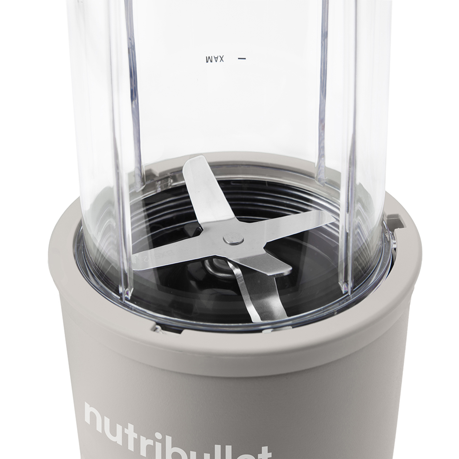 Close-up of the blender. Blades and the maximum fill line are visible.