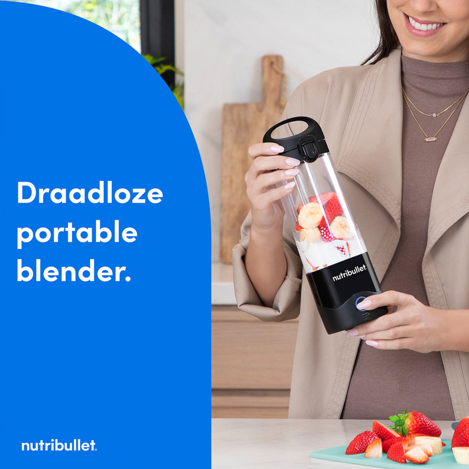 Woman holding a portable blender with fruits. Blue area with text.