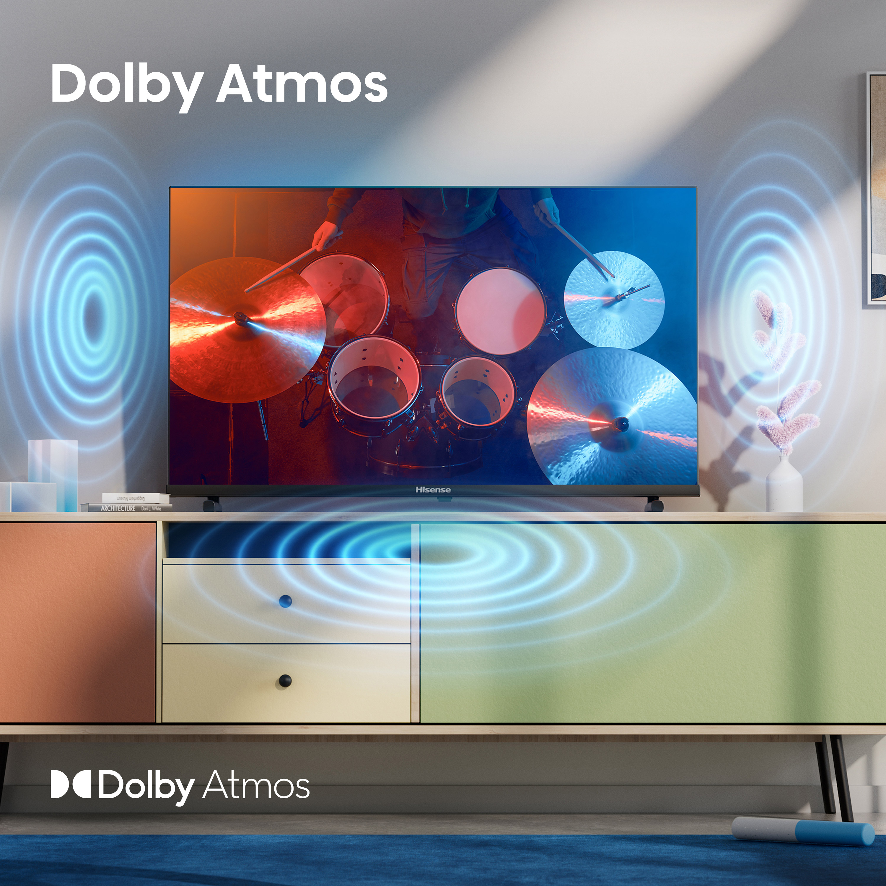 Egy TV egy dobost mutat, kék körökkel körülvéve, a Dolby Atmos-t reprezentálva.