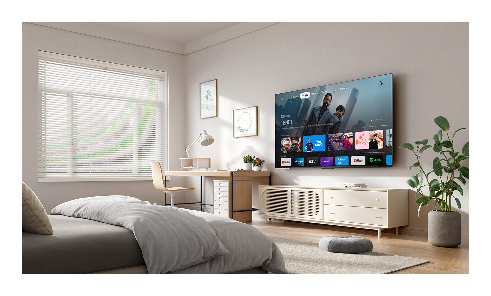 Un televisor montado en la pared de una sala de estar. Hay una cama, un escritorio y una ventana.