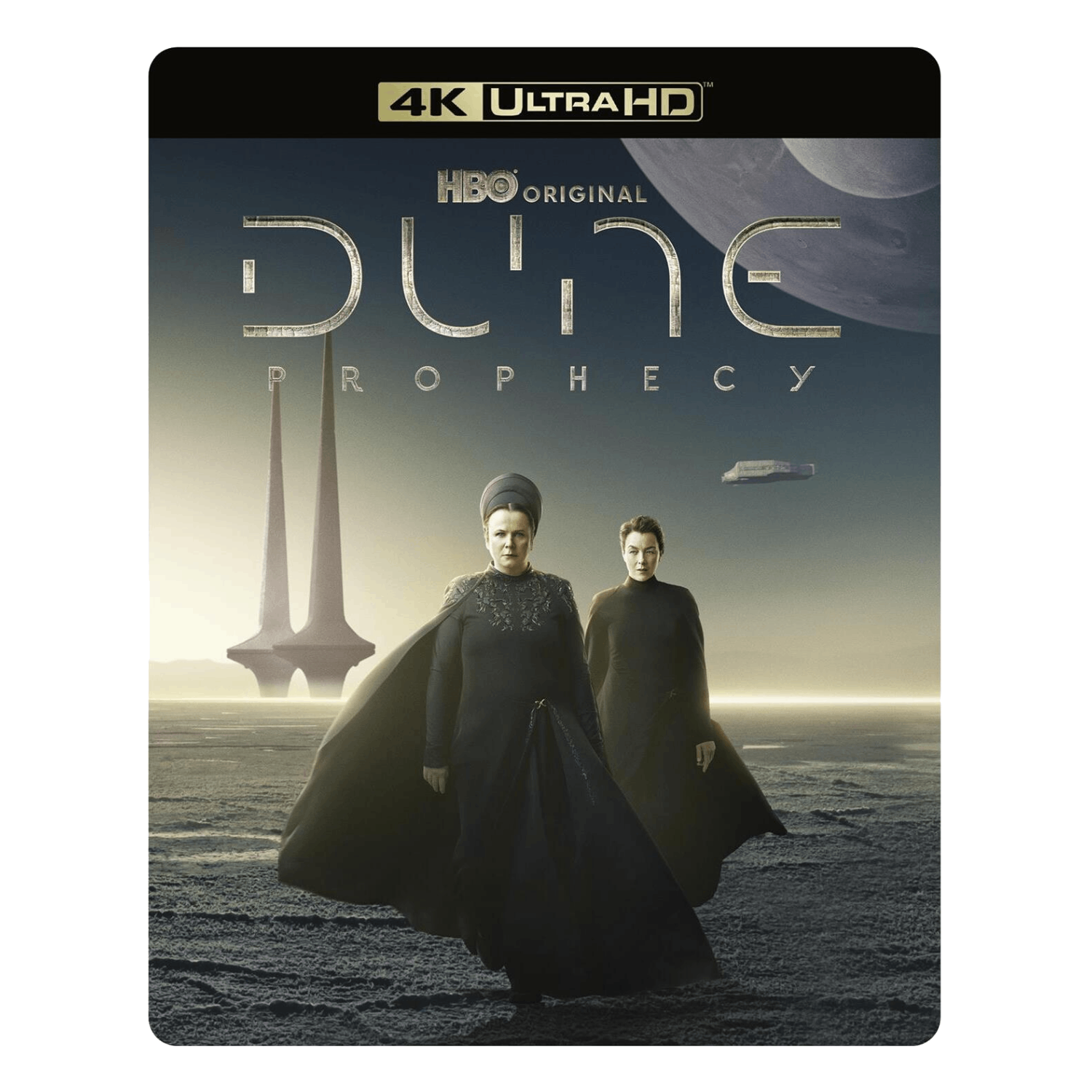 Couverture de Dune: Prophecy. Deux femmes en robes noires sur un paysage aride. Une ville futuriste en arrière-plan. HBO original.