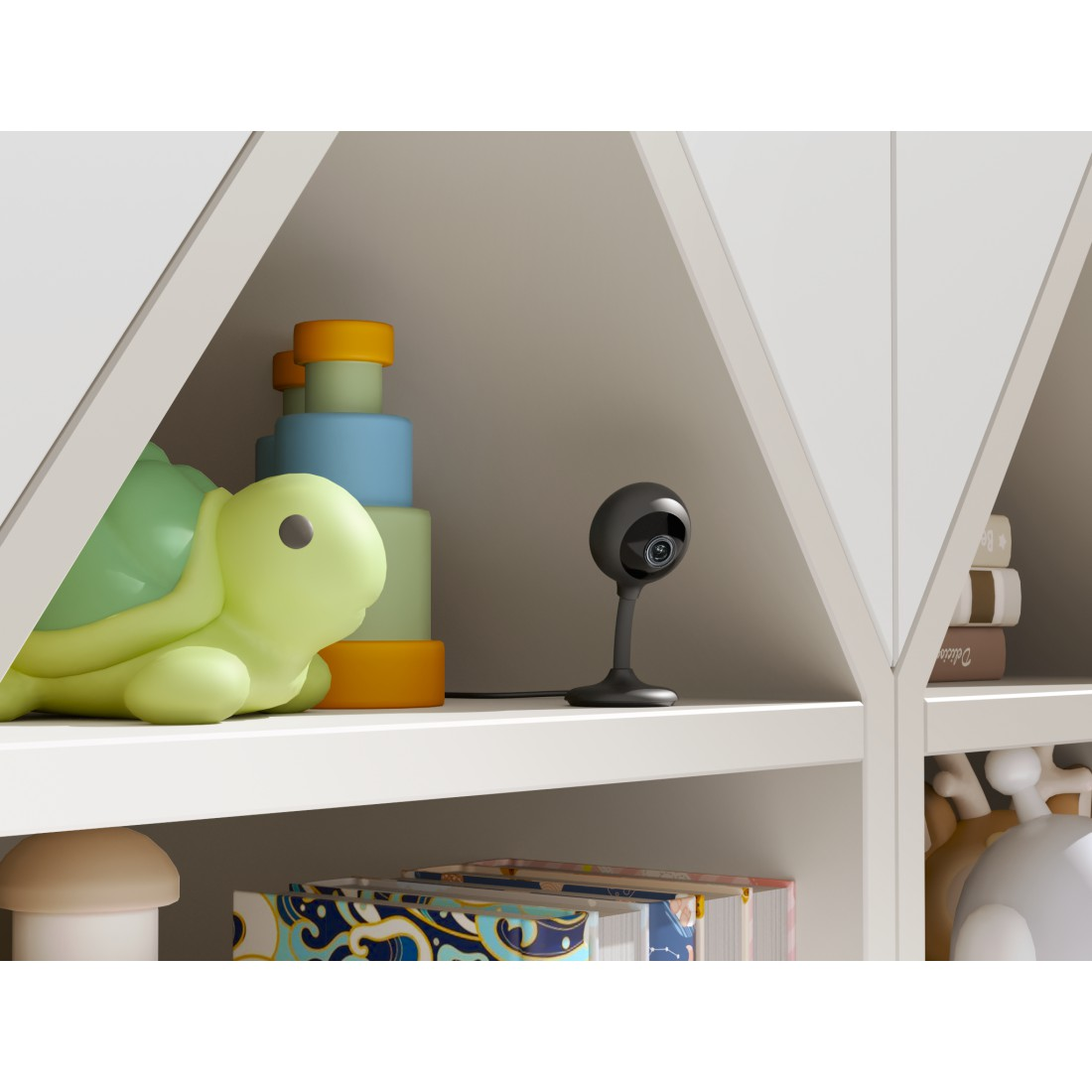 Babyphone auf Regal. Schildkrötenspielzeug und Bücher in der Nähe. Weiße Regale.