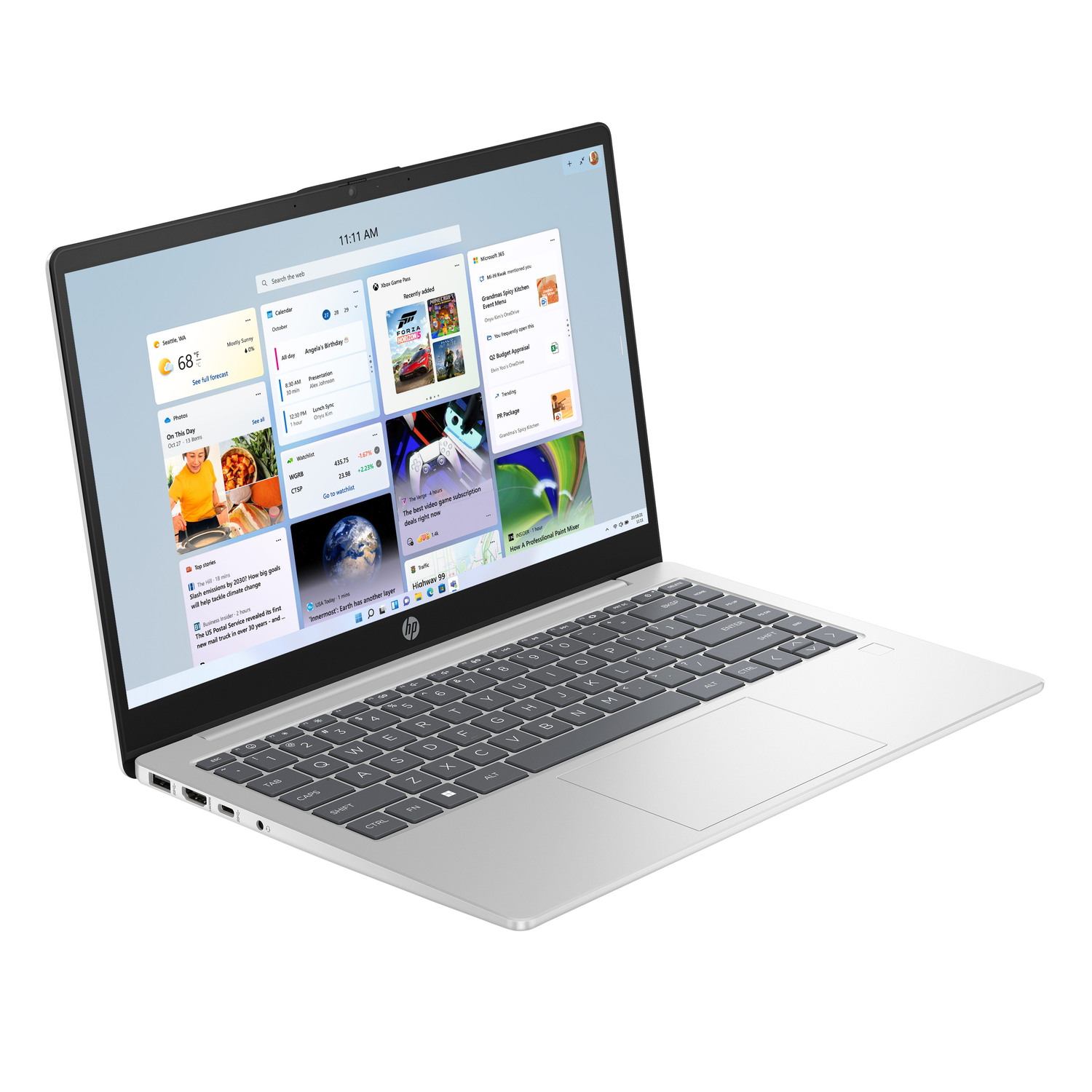 Silver laptop with open screen displaying news feed. Keyboard visible. White background.