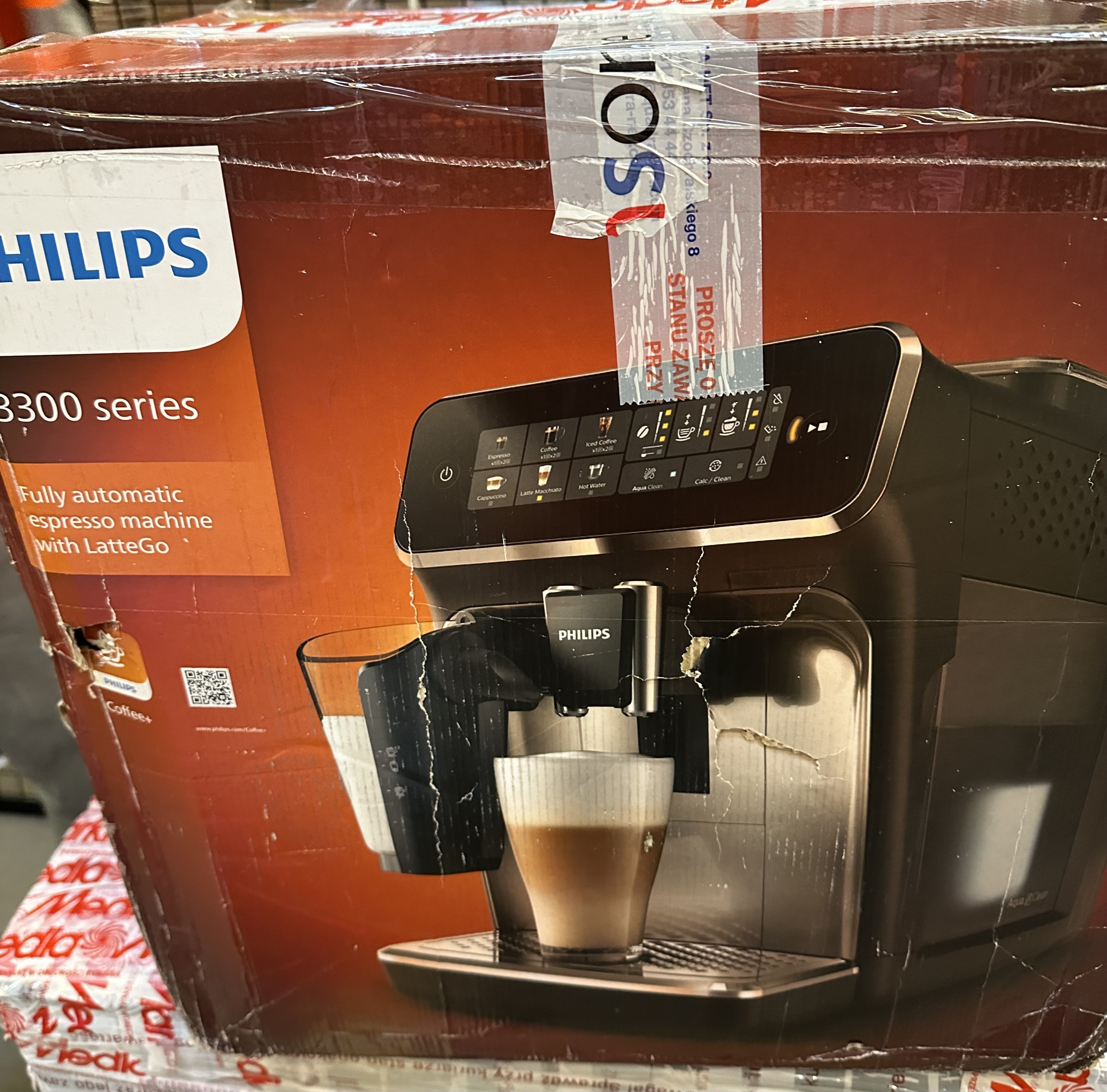 Ekspres do kawy Philips z systemem LatteGo. Maszyna jest brązowa, z ekranem dotykowym i filiżankami do kawy.